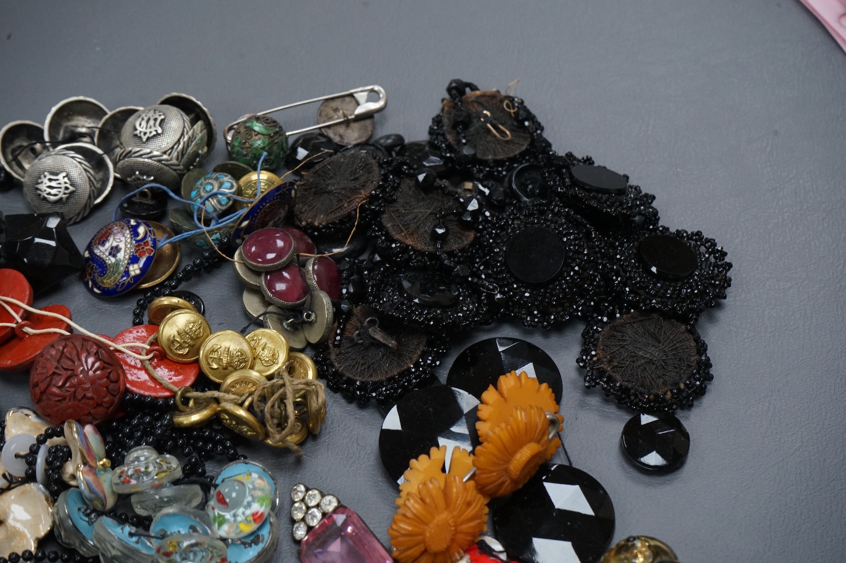 A collection of late 19th and 20th century buttons, some novelty, made from varying materials, metal, bakelite and glass.